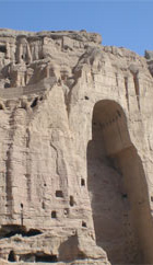 A cliff with caves and a huge carving